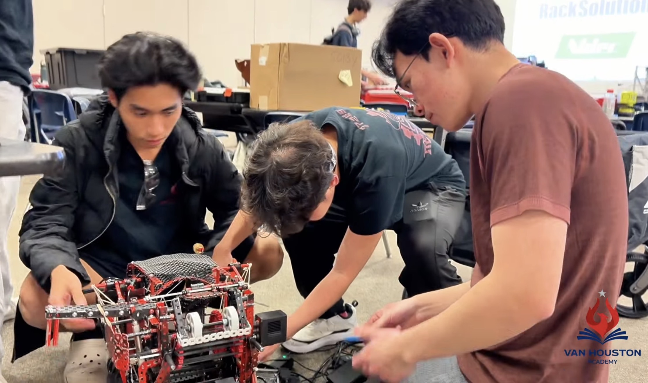 VEX Robotics Team 77245B members working together on their competition robot